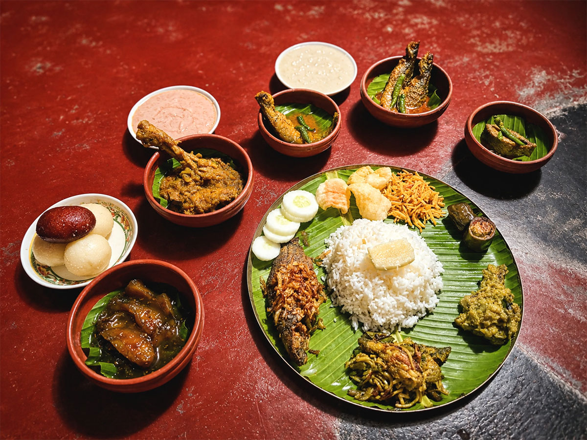 Traditional Bengali Dishes Served on a Banana Leaf Traditional Bengali Dishes Served on a Banana Leaf